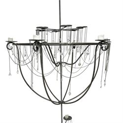 Large bespoke wrought iron cage candle chandelier, the top tier with six extending branches over bell-shape cage with scrolled supports and six branches, six branch lower tier; together with ceiling winch 