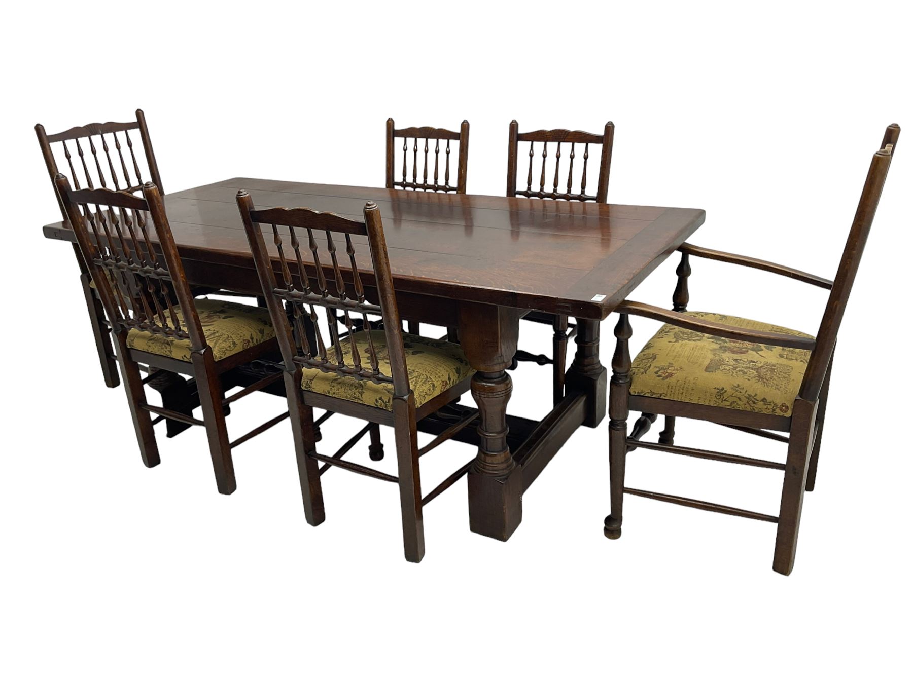 Oak refectory dining table, rectangular cleated top on turned supports joined by H-stretcher; together with set of six (4+2) oak spindle back dining chairs, with upholstered drop-on seat cushions, turned supports joined by turned stretchers