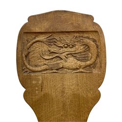 Gnomeman - two oak spinning or hall chairs, shaped splat backs, one carved with Yorkshire Rose, the other with mythical dragon, decagon seats on chamfered square tapering supports, each carved with gnome signature, by Thomas Whittaker, Littlebeck