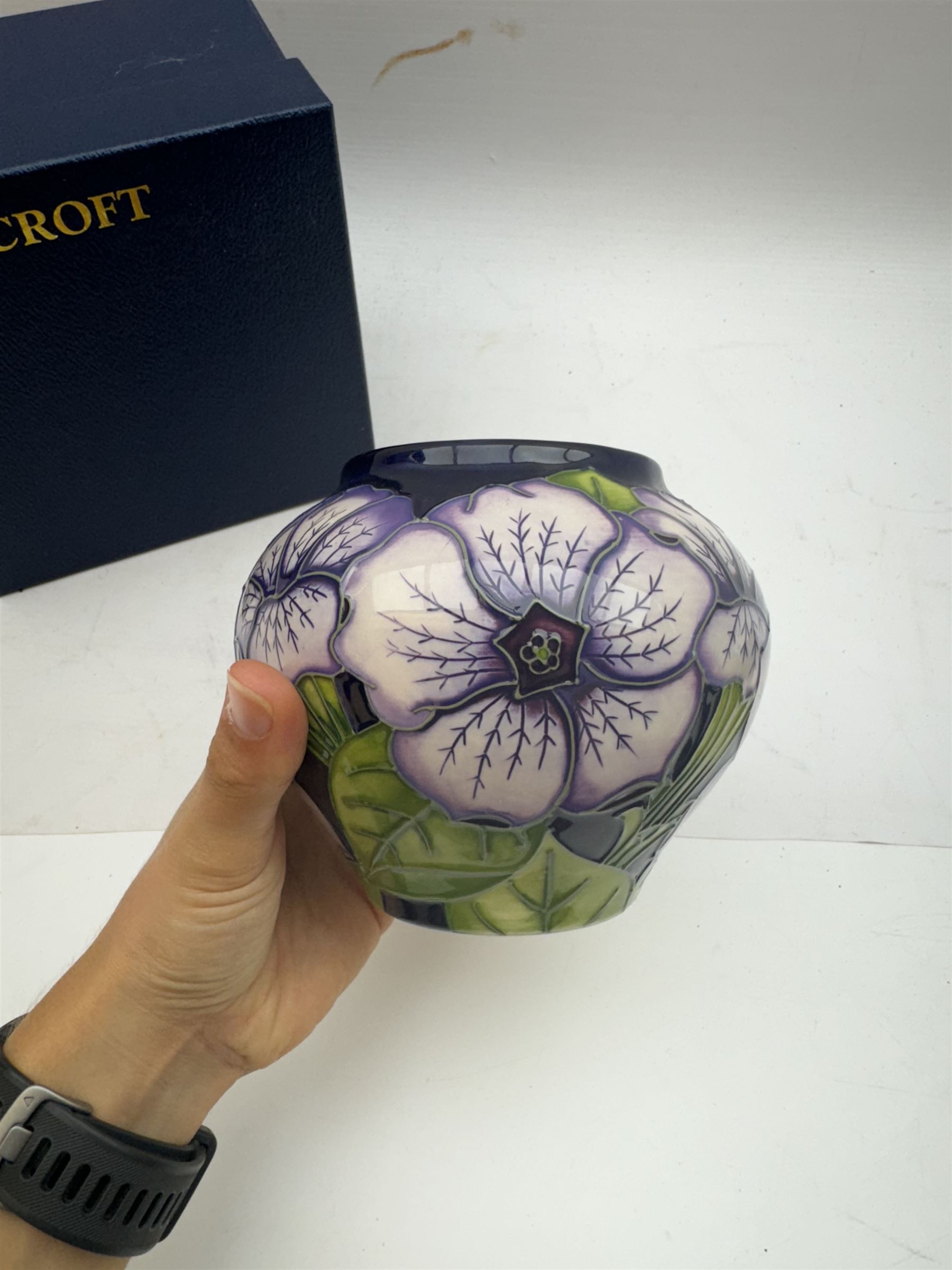 Moorcroft vase in Petunia pattern upon a ble ground, of squat baluster form, marked made for collectables to the base,  with original box, H12cm