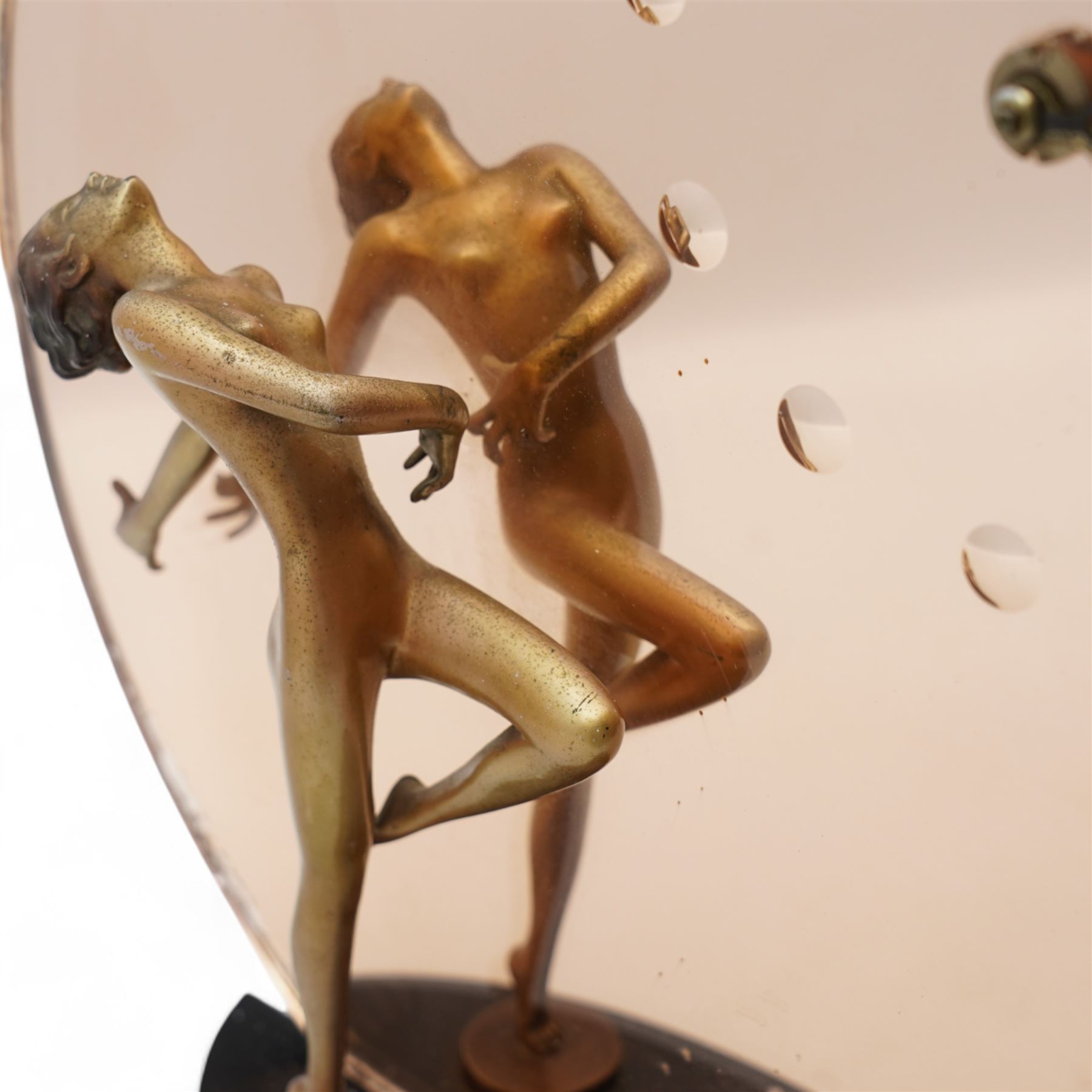 Josef Lorenzl (Austrian 1982-1950): Art Deco figural clock, circa 1930, modelled as a cold painted bronze female nude dancer before a rose-tinted mirror panel with integral clock, on ebonised plinth, the figure inscribed 'Lorenzl', with Smith's bakelite cased electric timepiece, H37.5cm x W37cm 