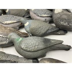 Fourteen Wood Pigeon decoys, together with camouflage netting