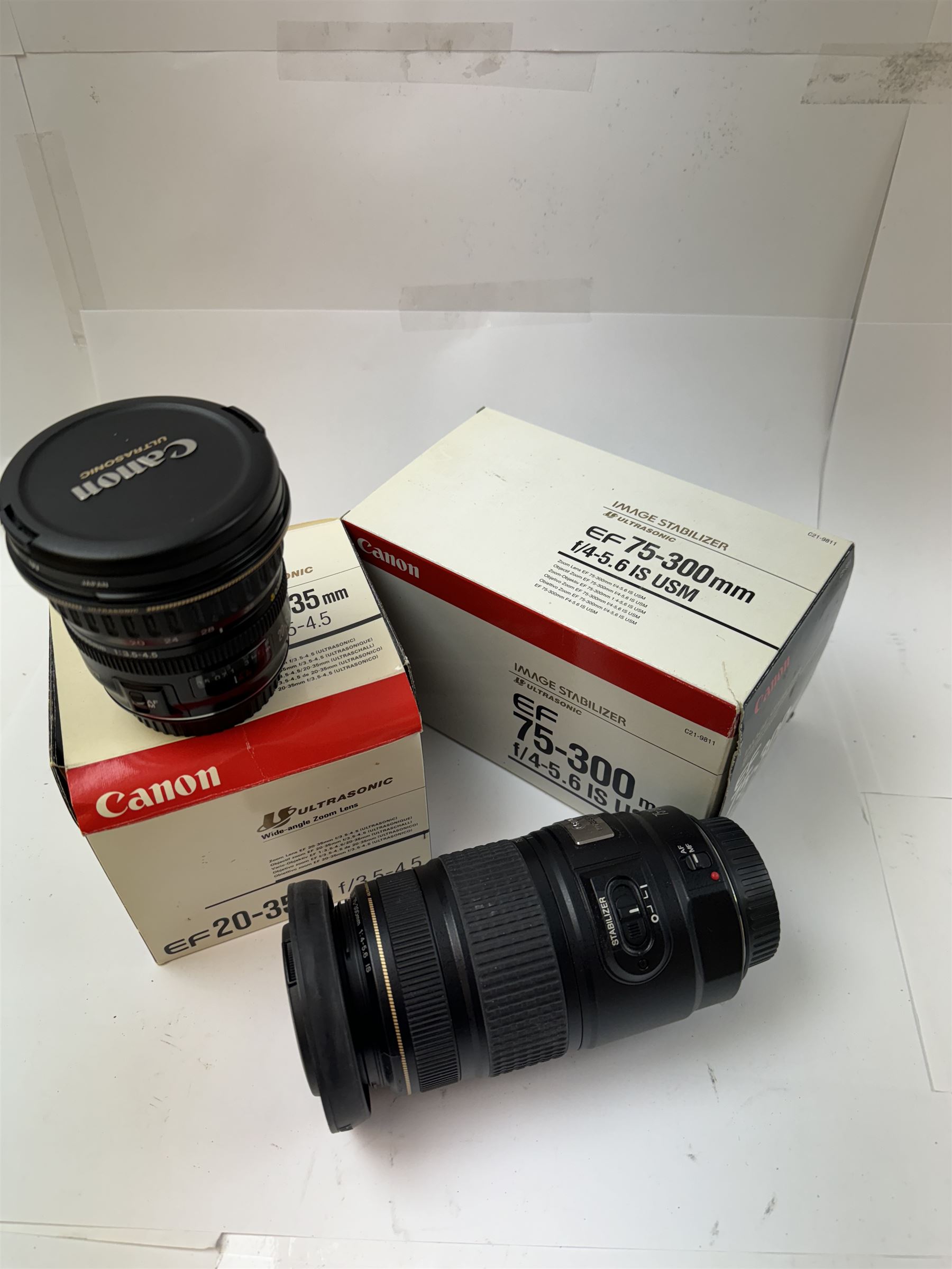 Two Canon Ultrasonic EF camera lenses, comprising 20-35mm 1:3.5-4.5 zoom lens serial no. 7800971F and 75-300mm 1:4-5.6 Image Stabiliser lens serial no. 6200116H, both boxed 