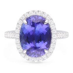 18ct white gold oval cut tanzanite and round brilliant cut diamond cluster ring, with diamond set shoulders, hallmarked, tanzanite 5.83 carat, total diamond weight 0.54 carat