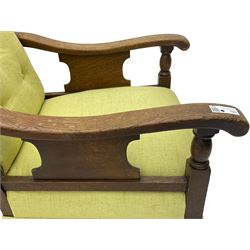 20th century oak framed rocking chair, curved armrests with shaped support panel, upholstered in lime-green fabric with button-tufting on the backrest, concealed springs to facilitate rocking motion underneath, supported by turned front legs with castors