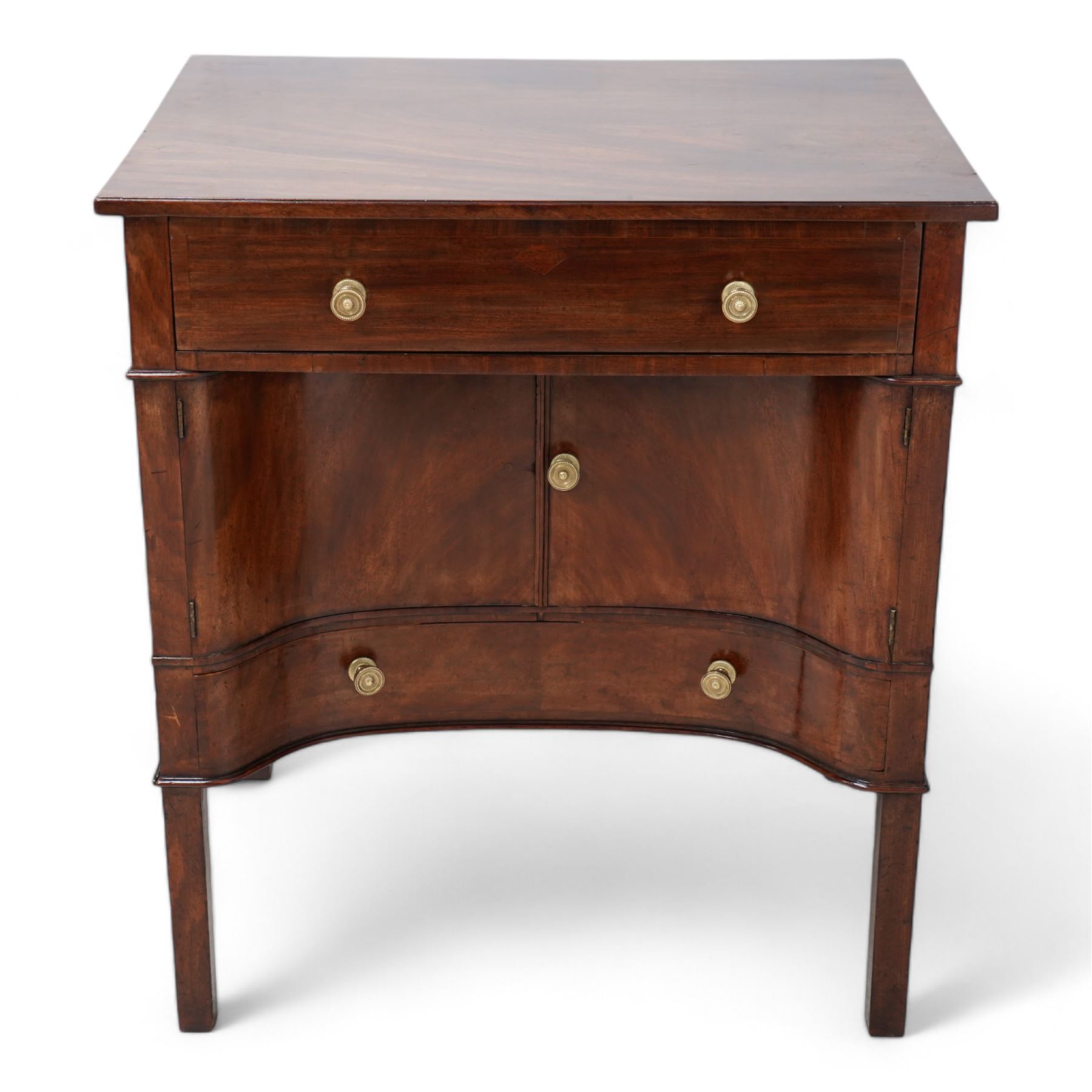 George III mahogany concave side cabinet, rectangular protruding top over a single drawer, the recessed concave body fitted with a double cupboard and single drawer, lower moulded edge on square supports