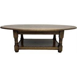 Traditional oak coffee table, moulded oval top, four turned pillar supports united by undertier