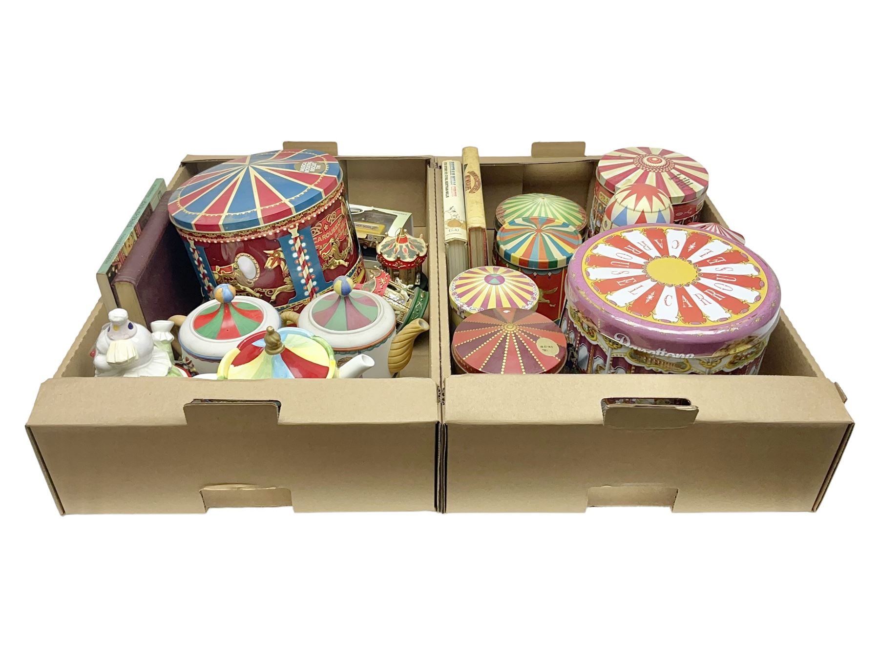 Collection of circus and fairground collectables, to include teapots, biscuit tins, including musical examples, and four Circus/fair themed books, including two library first editions