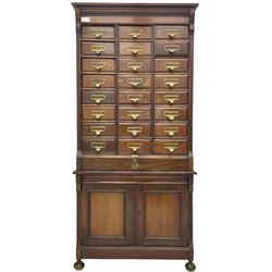 The Shannon Limited - late Victorian walnut filing cabinet, fitted with twenty-four small filing drawers, each with brass handle with label holder, fluted uprights, double cupboard below enclosed by two panelled doors, on turned feet, with brass plaque inscribed 'The Shannon, Limited, Ropemaker St. London, E.C.'