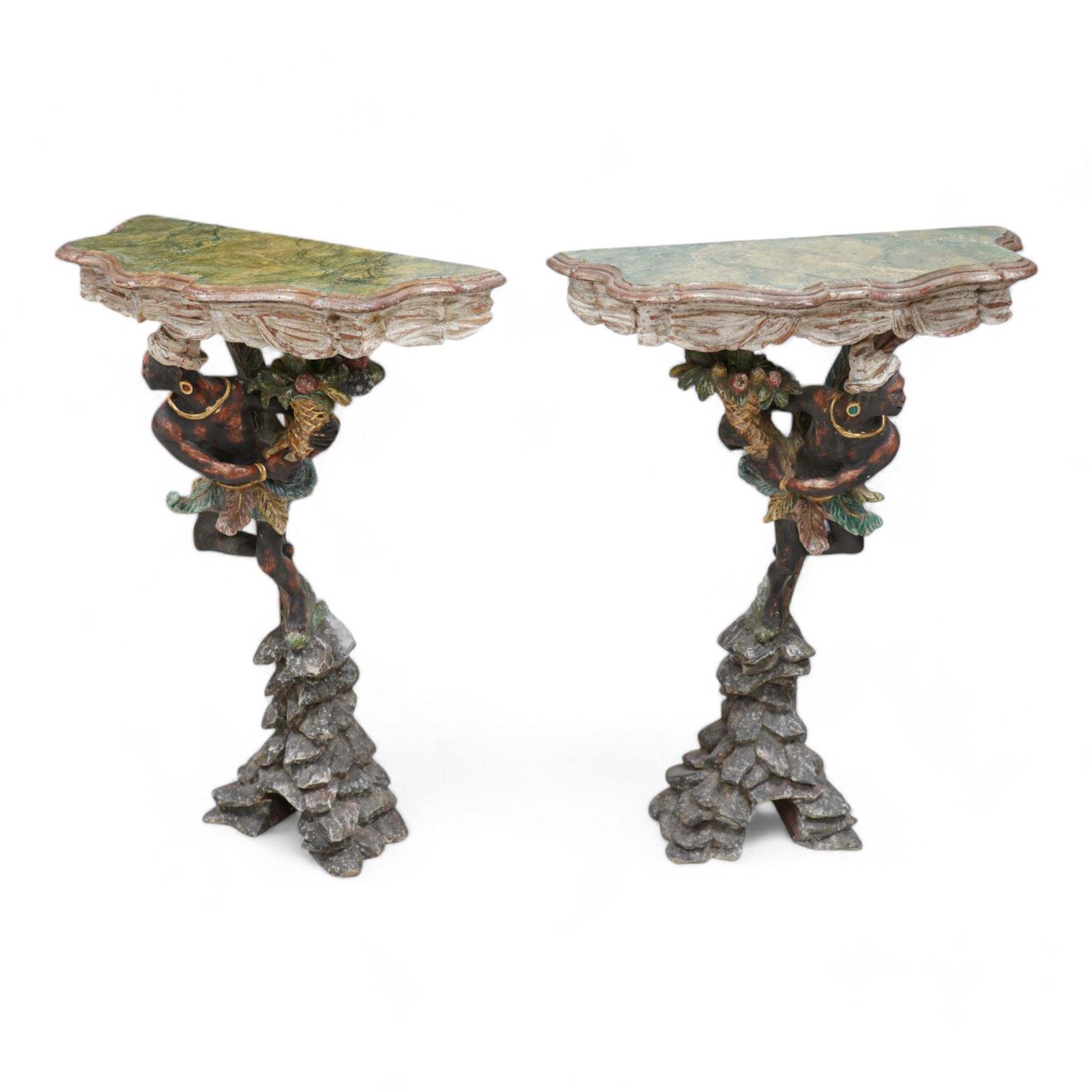 Pair of Venetian 18th century design figural polychrome painted console or torchère tables, green marbled demi-lune top with moulded scalloped edge, over a carved frieze in the form of white swags, the figural pedestal bearing a cornucopia, and dressed in a white turban and ostrich feather skirt over a down-scrolling acanthus support, standing upon a naturalistic rock carved base