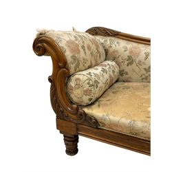 Victorian rosewood chaise longue, rolled back rest and shaped cresting rail carved with curled leaves and scrolls, upholstered in floral pattern fabric with bolster cushion, moulded lower rail with rectangular panel, on turned and lappet carved feet