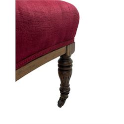 Late Victorian inlaid walnut two seat settee, the shaped cresting rail decorated with foliate inlays and boxwood stringing, upholstered in crimson velvet with sprung seat, raised on turned and fluted supports with ceramic castors