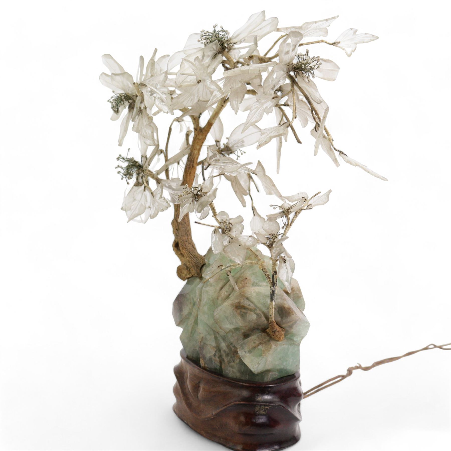 Early 20th century Chinese carved fluorite and crystal table lamp, depicting a blossoming tree on a rocky outcrop, on a carved hardwood stand inset with a bulb, H40cm