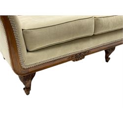 French design stained beech framed three-seat sofa, moulded frame carved with flowers and foliage, upholstered in pale neutral fabric, the moulded lower rail carved with flowerheads, on acanthus leaf carved cabriole feet