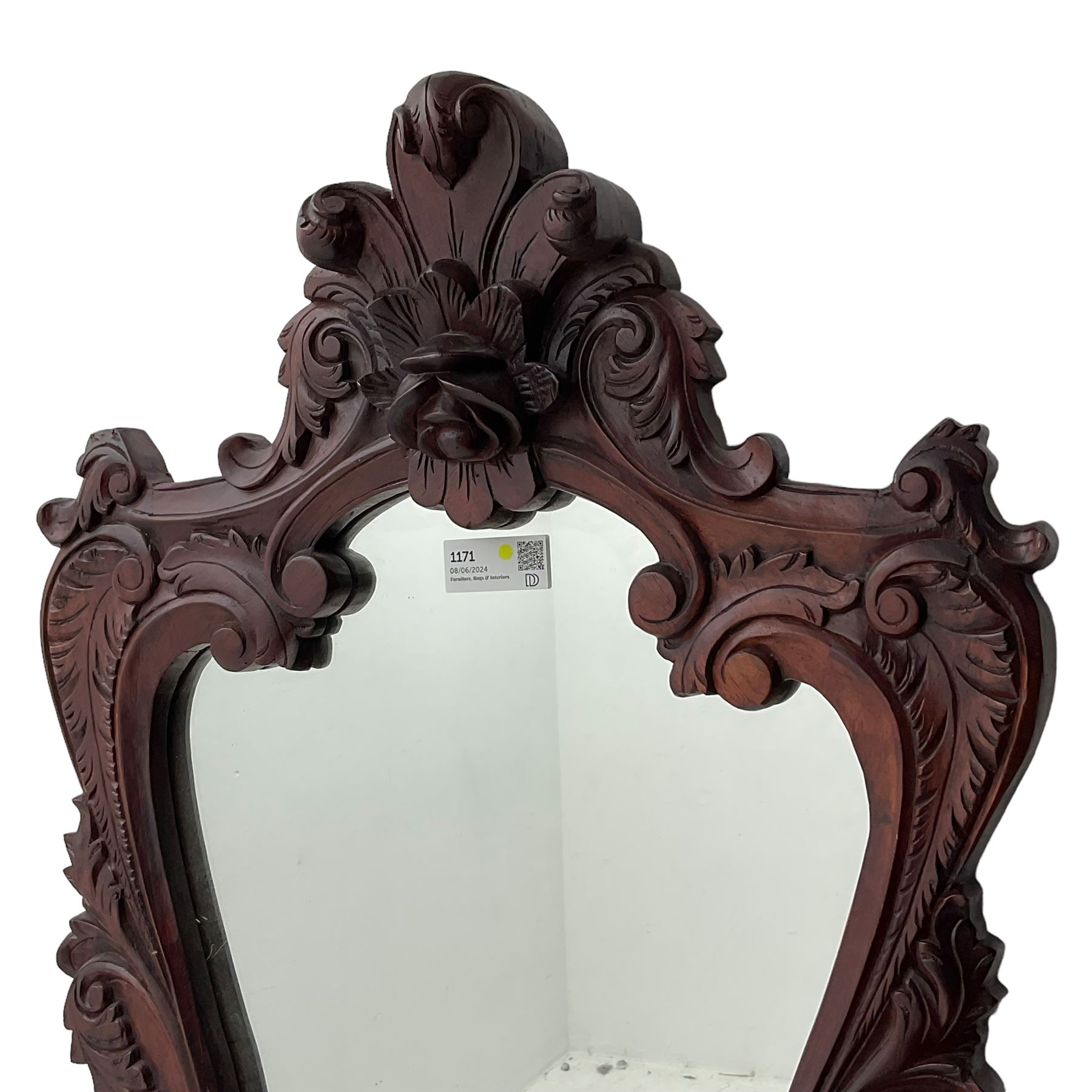 Pair of carved hardwood wall mirrors, shaped floral carved pediment over trailing and scrolled foliage decoration, plain mirror plate 