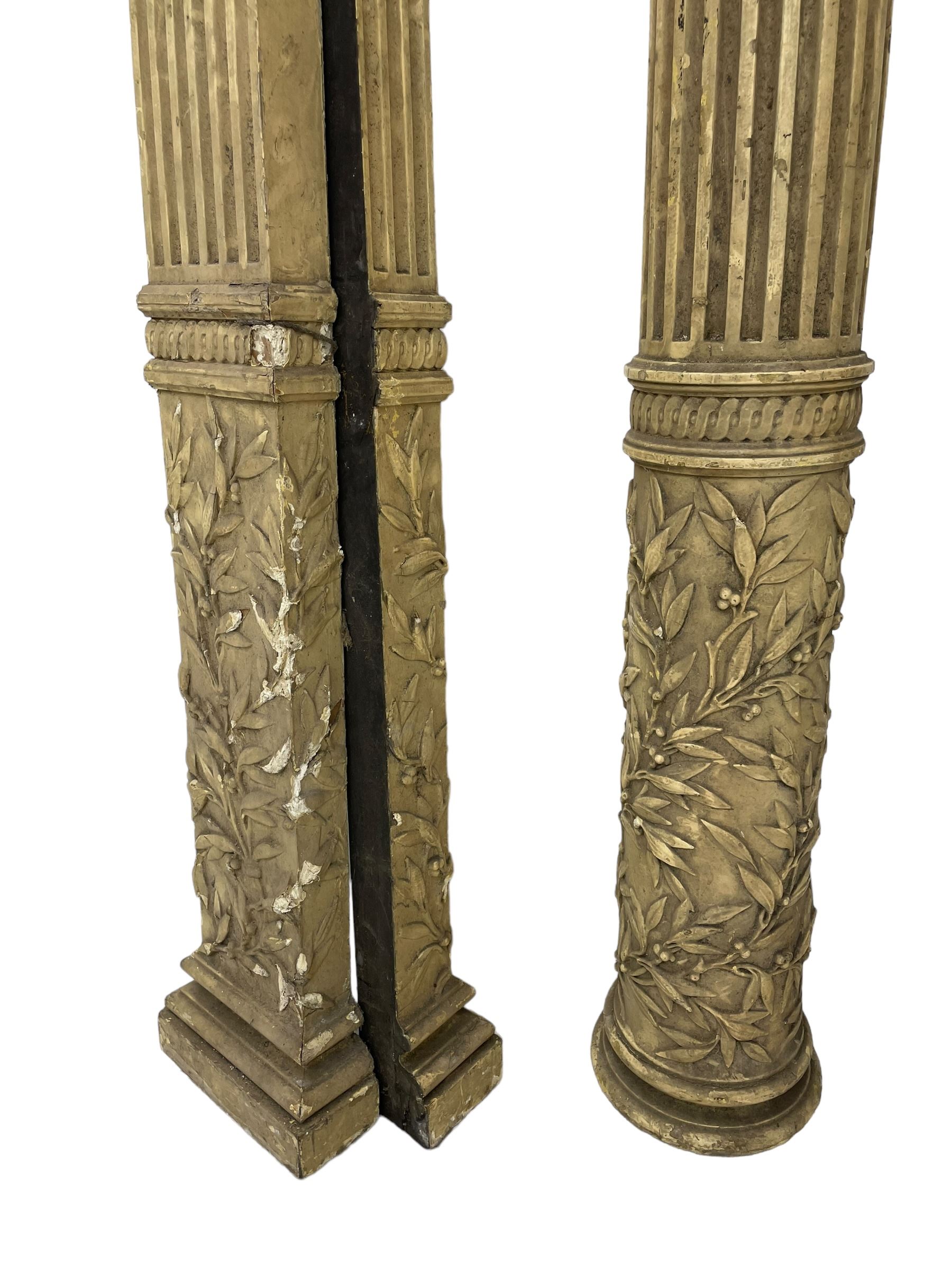 Three 19th century wood and gesso Composite order architectural architraves - curled acanthus leaf capitals over fluted shafts, the bases decorated with guilloche moulding over trailing laurel leaf branches, one half columns, one L-shaped rectangular pilaster and one full column, the largest - H204cm