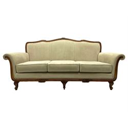 French design stained beech framed three-seat sofa, moulded frame carved with flowers and foliage, upholstered in pale neutral fabric, the moulded lower rail carved with flowerheads, on acanthus leaf carved cabriole feet