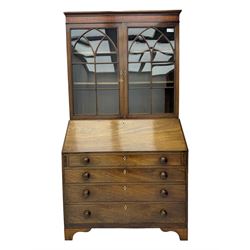 Early 19th century mahogany bureau bookcase, the projecting cornice over two Gothic-style astragal glazed doors enclosing two adjustable shelves, sloped hinged lid enclosing fitted interior and felt inset, four graduating drawers, on bracket feet