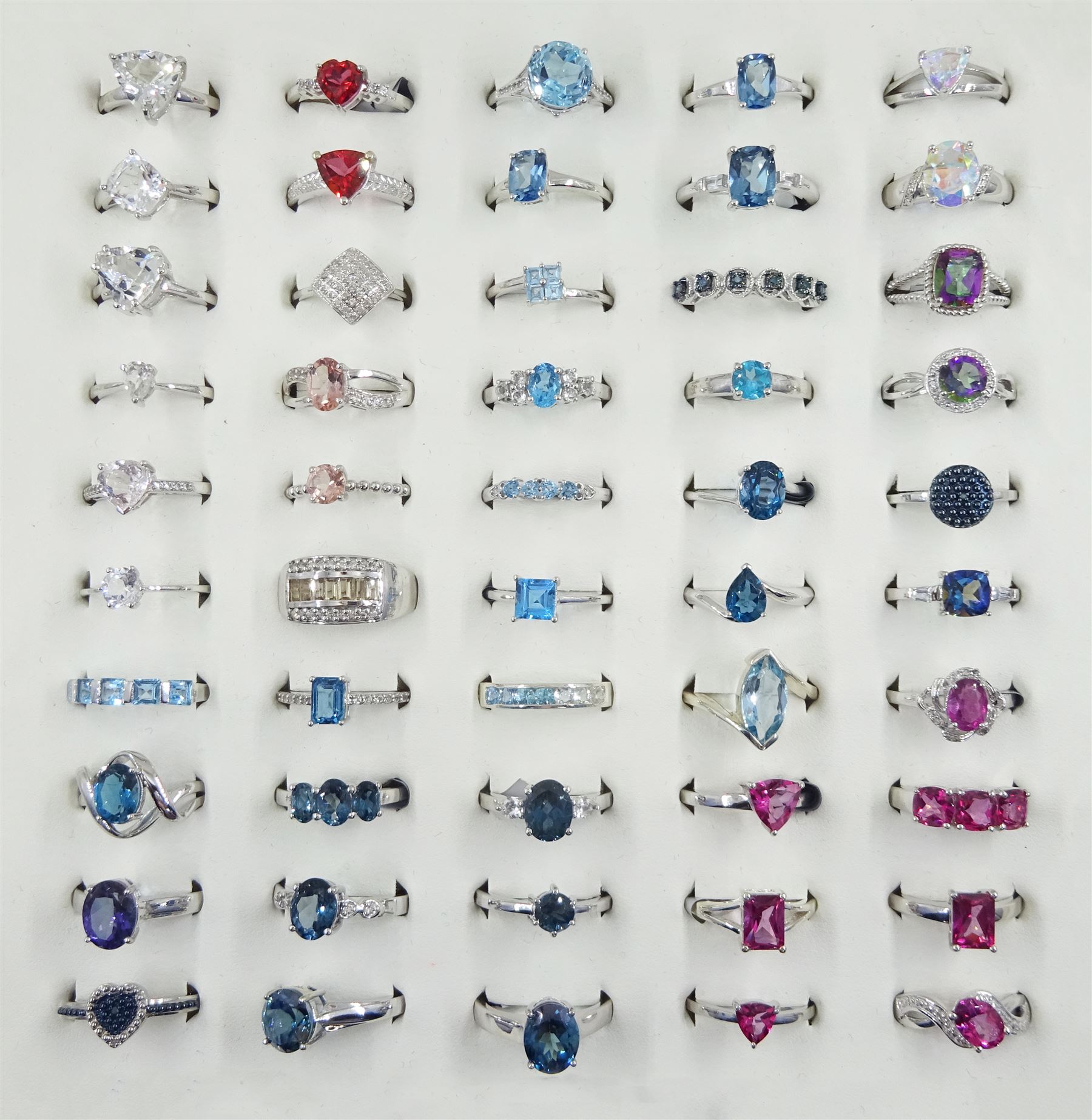 Forty-seven silver topaz rings including blue, mystic, pink and teal and three silver diamond rings including fancy blue and white