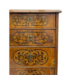 18th century inlaid walnut chest on stand, ovolo-moulded rectangular top inlaid with ebony panels each decorated with scrolling foliage, flower heads and birds, fitted with two short over three long drawers, the drawer fronts decorated with ebony panels enclosing curled leaf inlays, the base fitted with single drawer on turned supports united by waved stretchers, on turned bun feet 