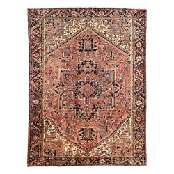 Persian Heriz pale ground carpet, large pointed rectangular medallion palmettes and traili...