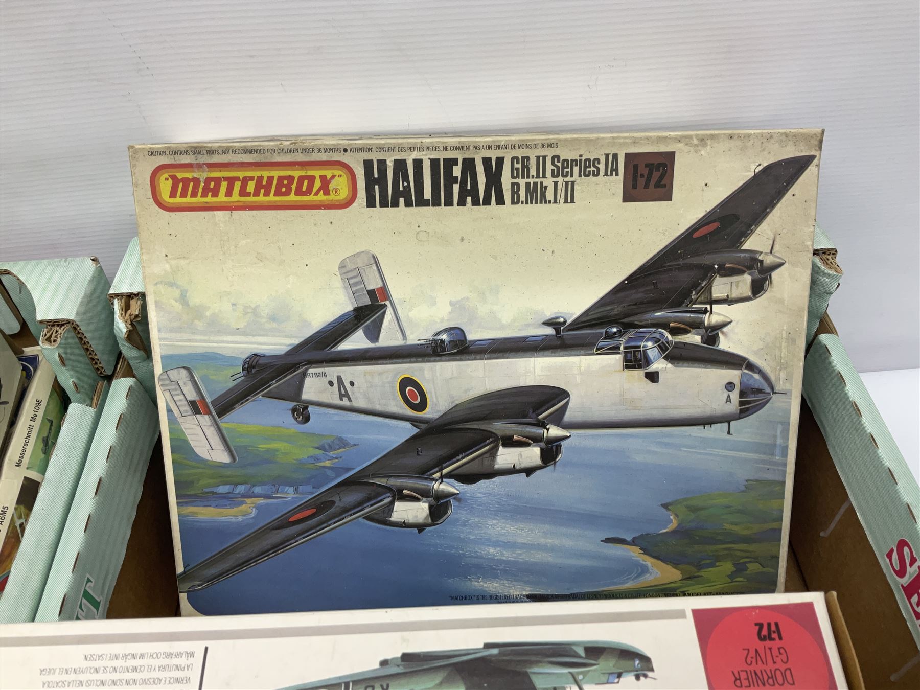 Twelve scale model kits, comprising ten model aircraft kits from Hasegawa, Nichimo, Fujimi and Matchbox, and two further Hasegawa 1:8 scale aircraft mounted machine gun kits, in two boxes 