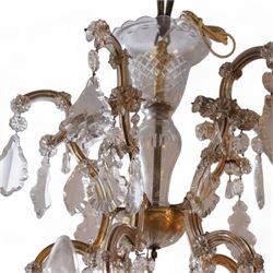 Large mid-to-late 20th century two-tier glass chandelier, shaped body dish over glass column, serpentine metal frame supporting fifteen branches, the frame clad with glass panels and decorated with drop pendants, each branch with glass bobeche decorated with drop prisms 