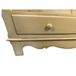 Provincial style cream painted bookcase, projecting cornice over dentil moulding, scalloped frieze above three open shelves, lower section fitted with two drawers, on bracket feet with apron