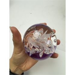 Two glass dump paperweights, with flower inclusions, together with four further glass paperweights