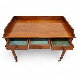 Gillows, Lancaster - early 19th century mahogany writing table, reeded three-quarter gallery over rectangular top with reed moulded edge, fitted with three cocked-beaded drawers with turned handles, the central drawer stamped 'Gillows Lancaster'. on turned supports with brass cups and castors 