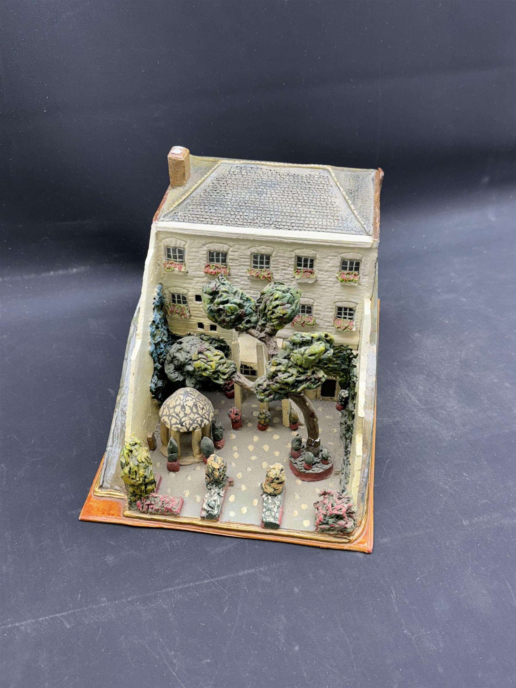 Mixed medium sculpture of house and garden, with makers mark beneath, H15cm