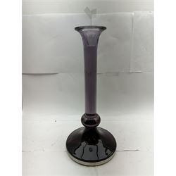 Large heavy gauge Scandinavian amethyst glass candlestick, the plain column with flared rim and basel knop, upon a spreading circular base, H44cm