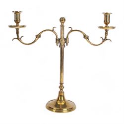 19th century brass adjustable candlestick, the spreading circular base leading to a basal knopped stem supporting adjustable twin scroll arms with urn shaped sockets above circular drip pans, H38cm W43.5cm