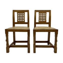 Rabbitman - set of six (5+1) oak dining chairs, pierced and carved lattice back, leather upholstered seat with stud band, on octagonal supports united by stretchers, carved with rabbit signature, by Peter Heap of Wetwang 