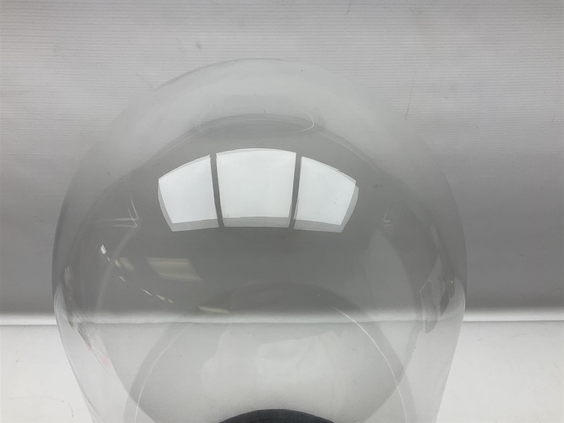 Glass dome upon circular base, H53cm