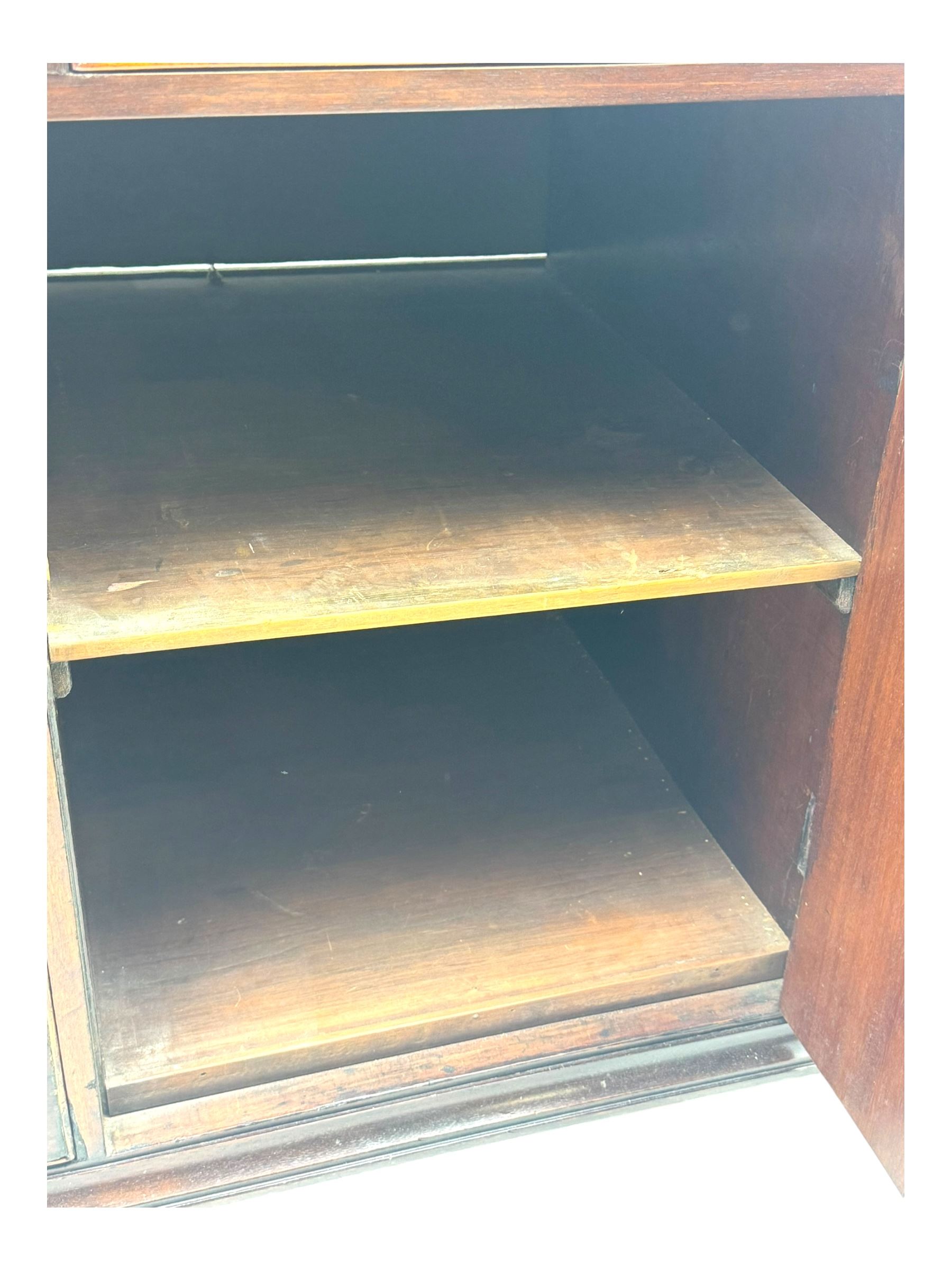 George III mahogany bureau, the fall-front enclosing fitted interior with pigeonholes and central cupboard, over an arrangement of nine short drawers surrounding a central cupboard, on shaped bracket feet