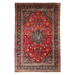 Persian Kashan crimson ground carpet, central rosette medallion on a field of trailing fol...