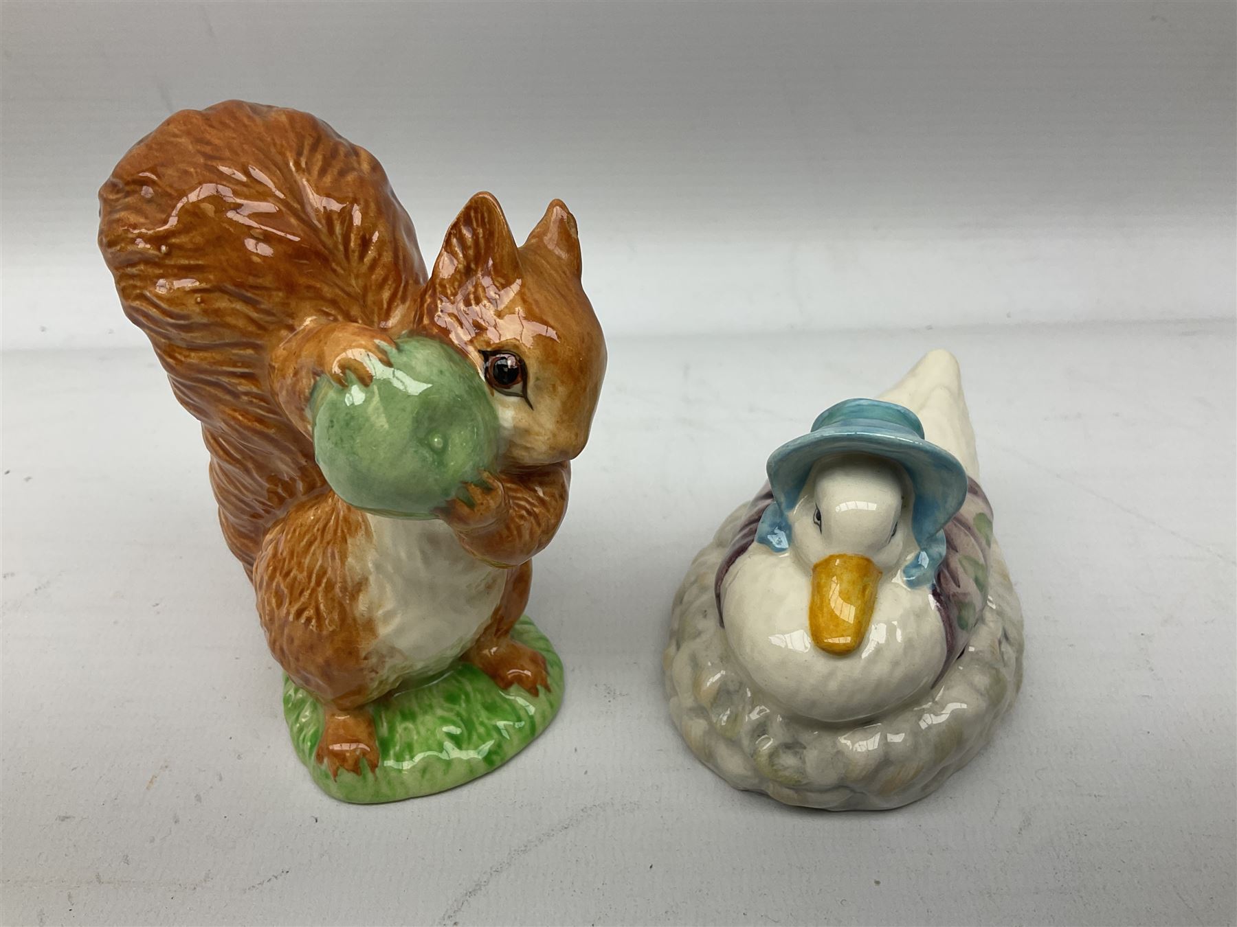 Collection of Beswick figures to include Beatrix Potter Squirrel Nutkin, Jemima Puddleduck, Spike and Tyke, Tom and Jerry, both boxed and with certificates, Chamois 1551 and Babycham 1615a (a/f) Beswick Ware Royal Douton Peter Rabbit and Benjamin Bunny, with certificate
(9)
