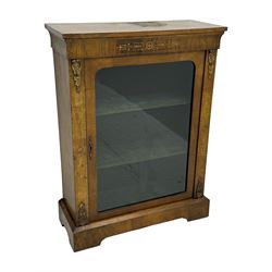 Late Victorian walnut pier cabinet, projecting cornice over frieze inlaid with foliate motifs, single glazed door flanked by ormolu mounts, enclosing shelved interior, on plinth base