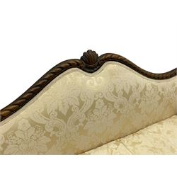 Victorian design walnut framed settee, shaped camelback with gadroon carved edge and central feather motif, upholstered in cream damask fabric with scrolling floral pattern, S-scroll arm facias carved with flower head and curled leaves, feather carved C-scroll splayed feet 