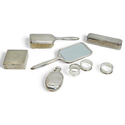 Silver oval spirit hip flask Sheffield 1899, engine turned silver square cigarette box, three piece silver backed dressing table set and three serviette rings 