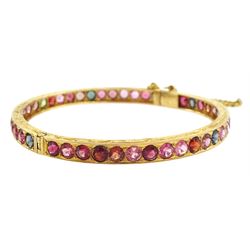 19ct gold multi gemstone hinged bangle, including topaz and tourmaline, the sides with bright cut decoration