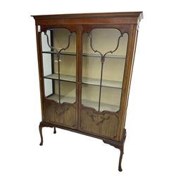 Early 20th century mahogany straight-front display cabinet, projecting moulded cornice over two astragal glazed doors with lower panels, on cabriole supports 