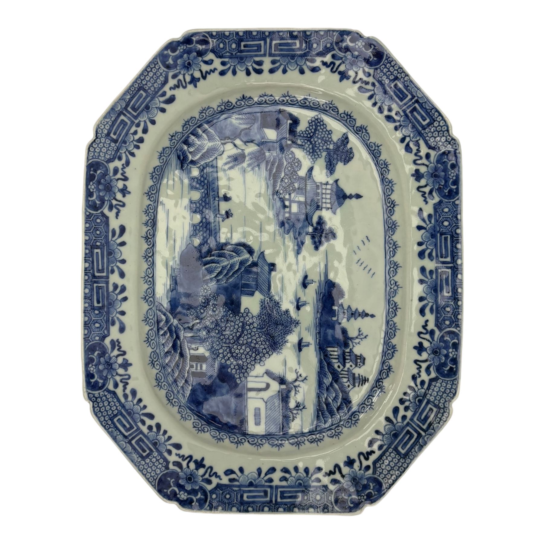 Six 18th century Chinese Export blue and white platters, each of rectangular canted form decorated with various landscape scenes, within foliate borders, max L45cm (6)