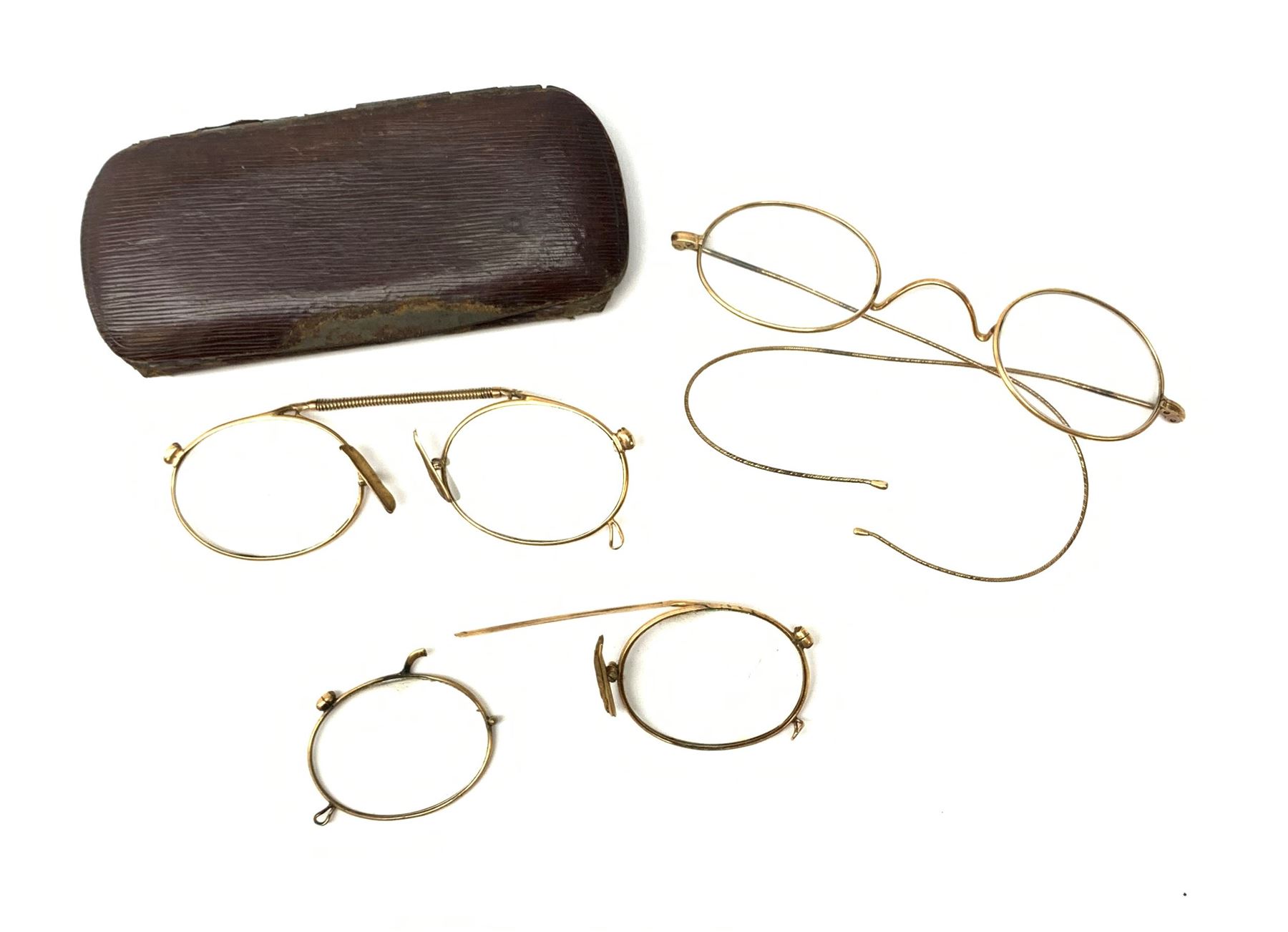 A pair of 9ct gold framed antique spectacles, marked 9 375, with case, together with a further pair, (testing around 9ct), and damaged pair (testing as gold plated). 