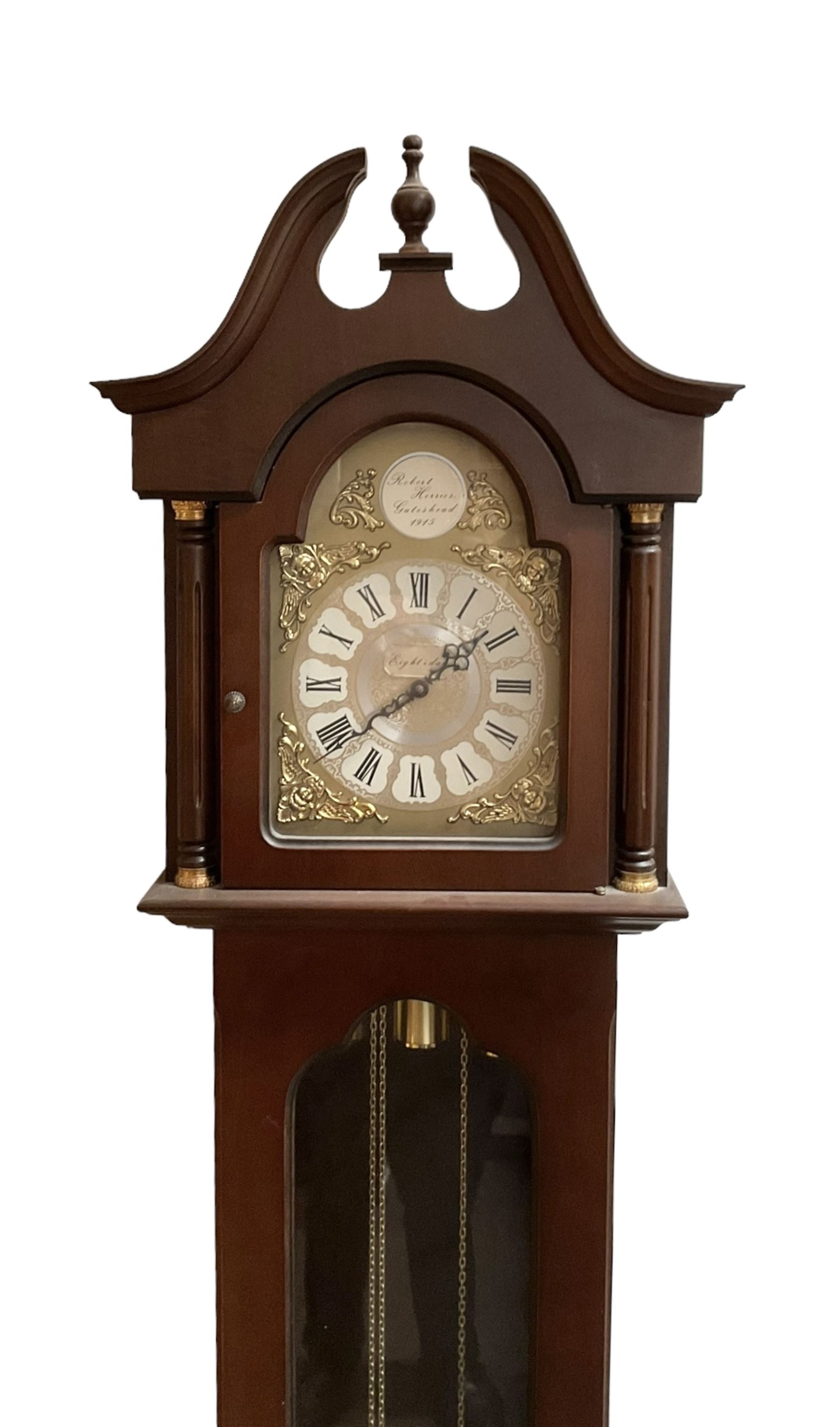 20th century - 8-day Mahogany longcase clock, with a swans necked pediment and break arch hood door beneath,  glazed door with visible brass cased weights and pendulum, on a rectangular plinth with a raised panel and bracket feet, brass dial with a silvered dial centre and chapter ring, chain driven three train movement chiming the quarters and hours on gong rods. With weights and pendulum.  