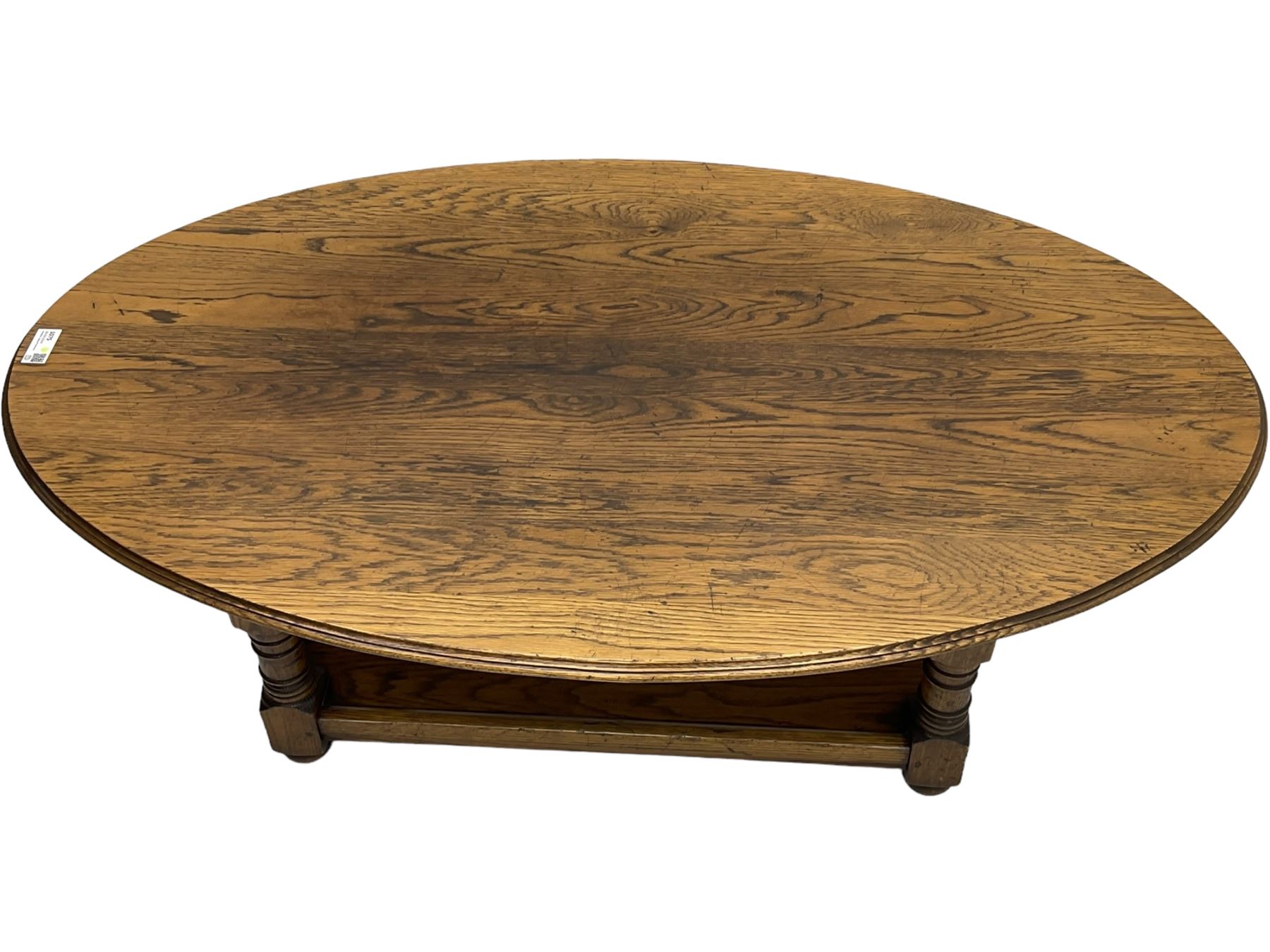 Traditional oak coffee table, moulded oval top, four turned pillar supports united by undertier