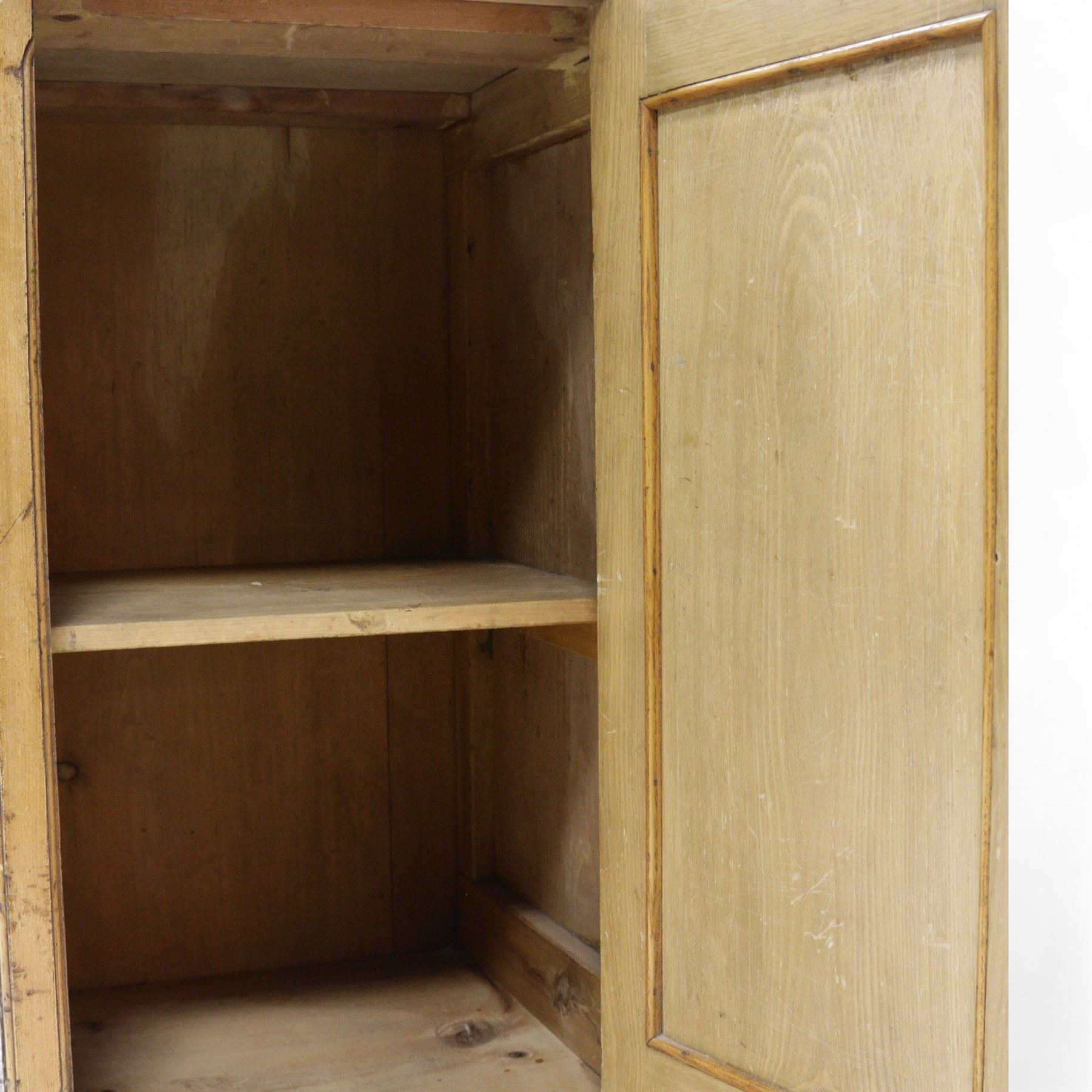 Late Victorian ash and walnut bedside pot cupboard, raised canted back over square moulded top, enclosed by single panelled door with figured walnut veneer, on bracket feet 