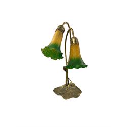 Art Nouveau inspired Tiffany style table lamp, with decorative lily pad base, and two ambe...