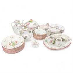 Keller & Guerin Luneville French part tea and dinner service,painted with floral sprays and scattered sprigs within pink edged rims, including covered dish, two meat platters, three coffee pots etc 